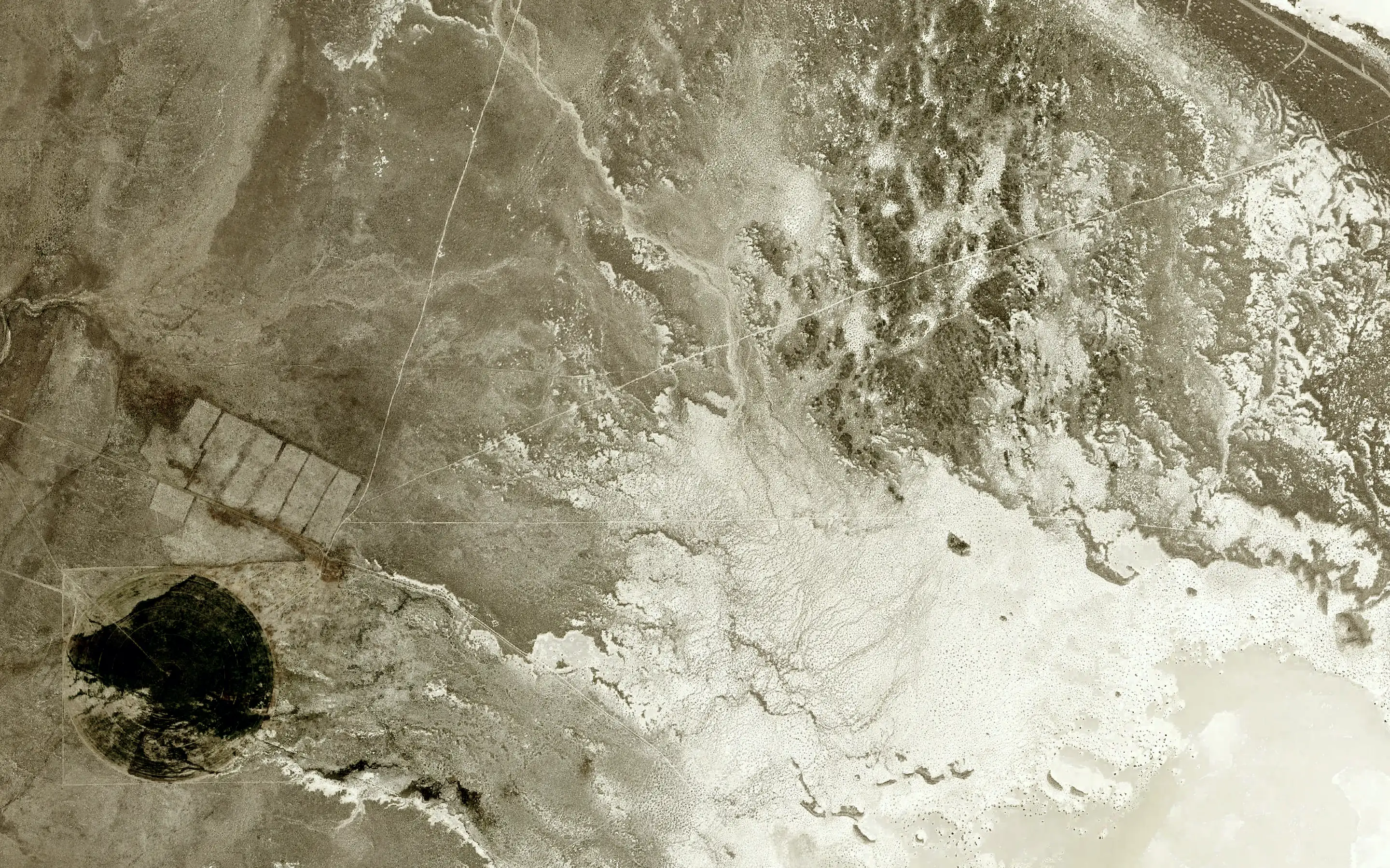 Aerial view: a basin floor and playa edge.